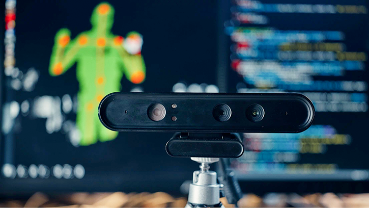 A depth camera and marked human silhouette in the background.