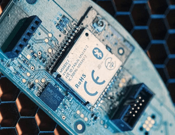 A printed circuit board under a magnifying glass.