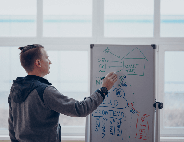Three warehouse employees check the batch data with the actual quantity of goods using a tablet app.