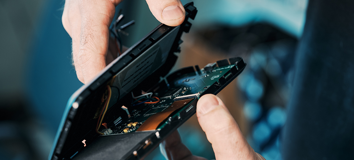 Integra Sources engineer is opening up the case of an electronic device.