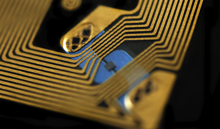 An electronics engineer is soldering an integrated circuit to a printed circuit board.