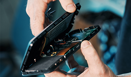 Integra Sources engineer is opening up the case of an electronic device.