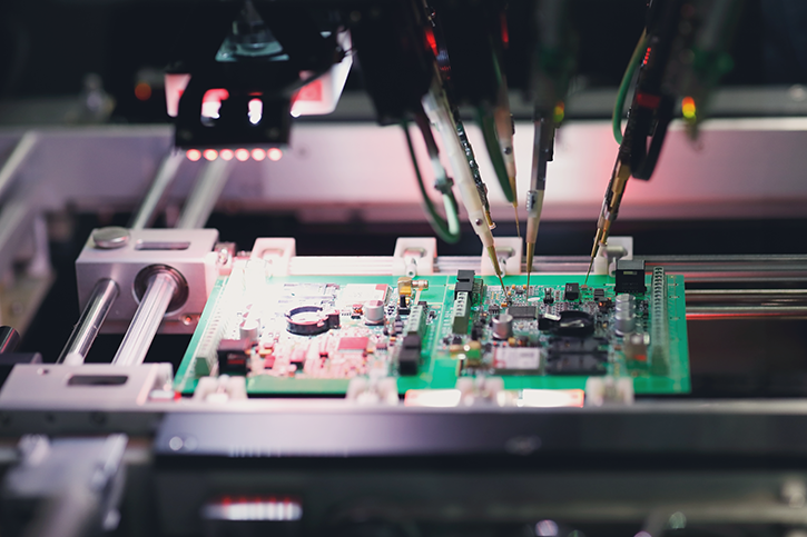 A Flying probe testing machine checking a circuit board.