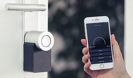 A smartphone held near a smart lock.