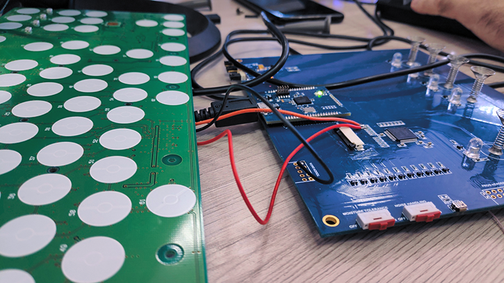 A capacitive keyboard connected to a printed circuit board.