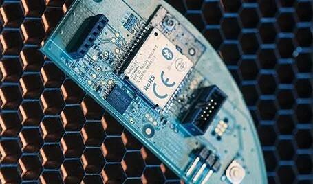 A printed circuit board with an FCC, RoHS, and CE certified component on it.