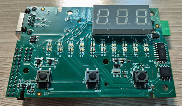 The printed circuit board of an industrial gas burner with indicator elements and three buttons