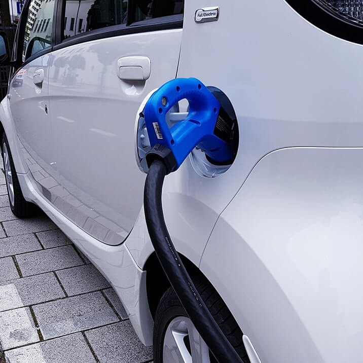 An electric vehicle is being charged on a charger station.