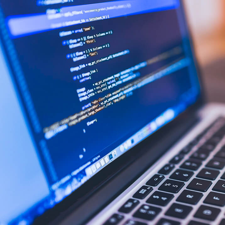A laptop with a programming code on the screen.