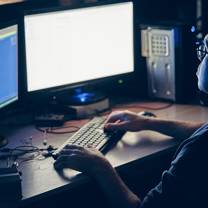 An Integra Sources programmer uses two monitors to work on code for an embedded application development project.