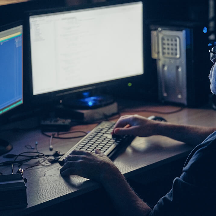 A man typing on a PC keyboard.