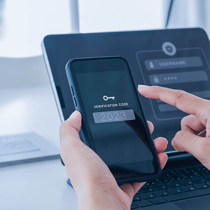 A man enters a verification code on the phone screen to unlock it.