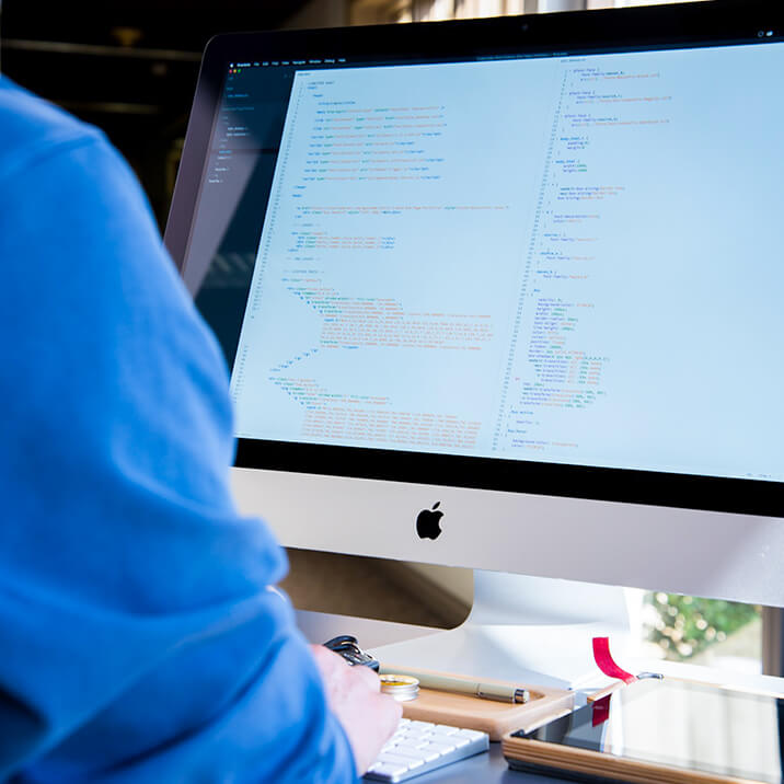 A man is developing a virtual driver on a Mac computer.