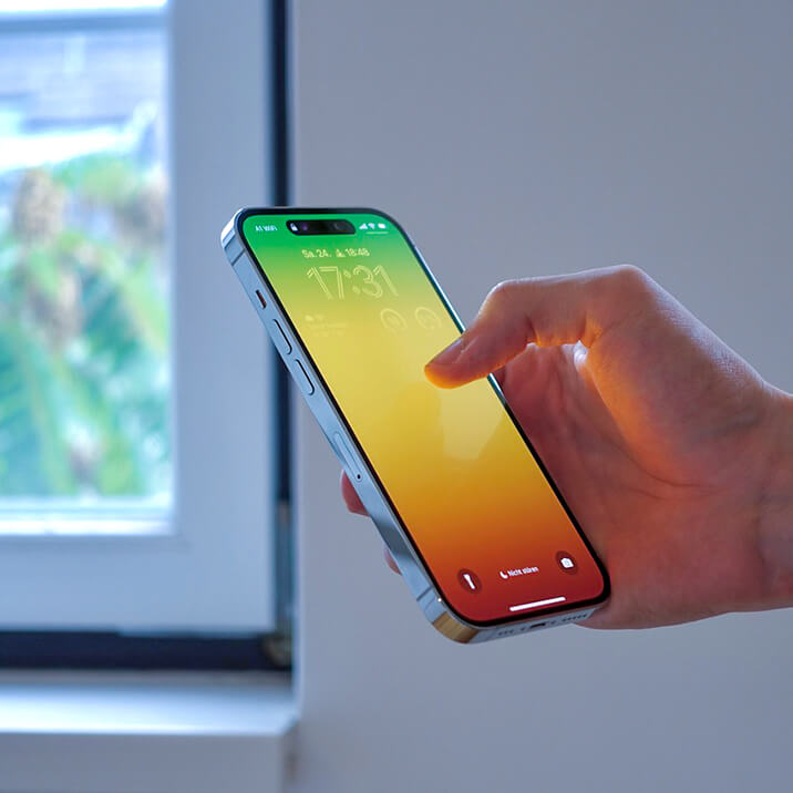 A man holding an iPhone in his hand