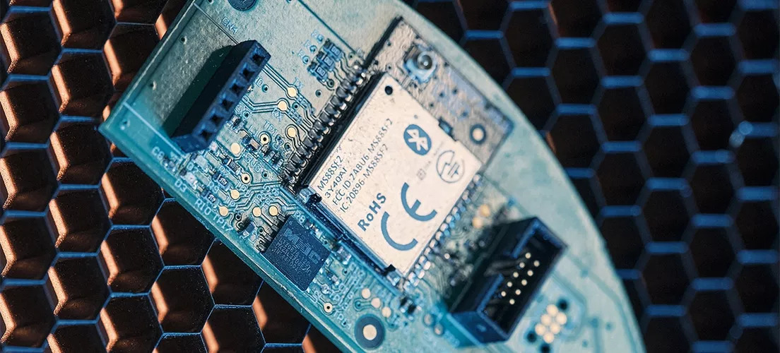 A printed circuit board with an FCC, RoHS, and CE certified component on it.